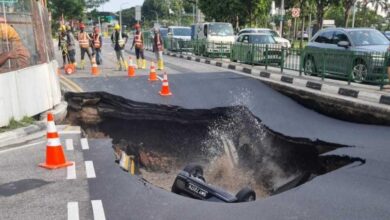 Woman taken to hospital after car falls into sinkhole on Tanjong Katong Road