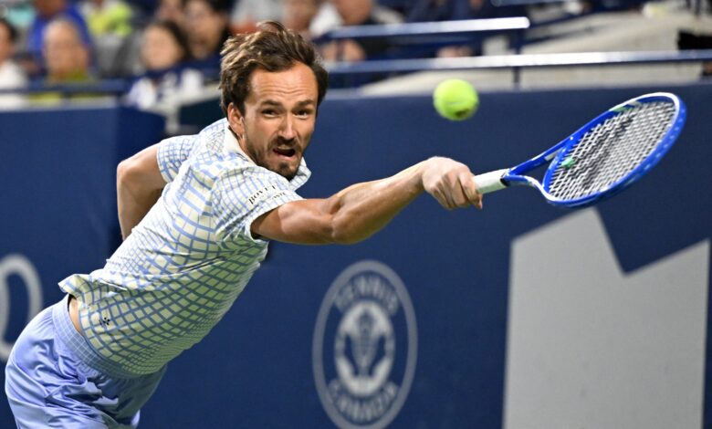 Jul 31, 2025; Toronto, ON, Canada; Daniil Medvedev plays a shot against Alexei Popyrin (AUS) during third round play at Sobeys Stadium.